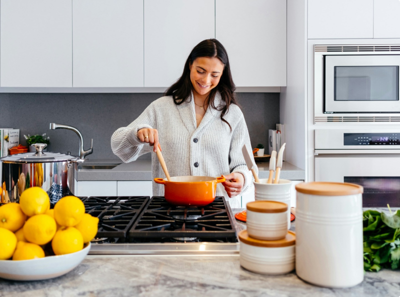 One lady is cooking in the kitchen